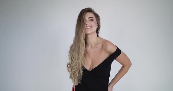 Attractive Girl Smiles with a Flirtatious Look Running His Hand Over His Face alt