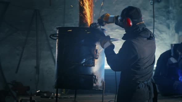 Assembling Metal Structures Making a Homemade Heater By a Professional Worker Using a Grinding alt