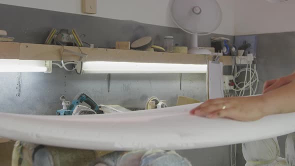 Male surfboard maker in his workshop alt