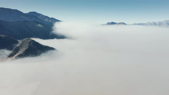 Beautiful Aerial Flying Above Death Valley Desert Covered By White Fog Clouds alt