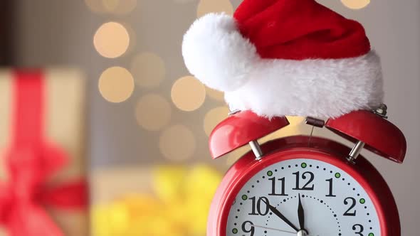 Vintage Alarm clock in Santa Claus hat with Christmas gift