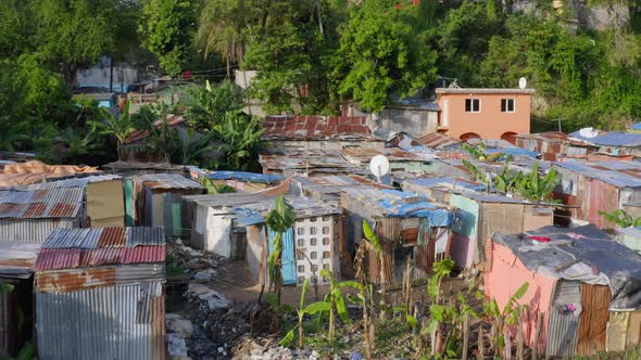 Aerial backward over dilapidated shacks near Ozama river, Santo Domingo alt