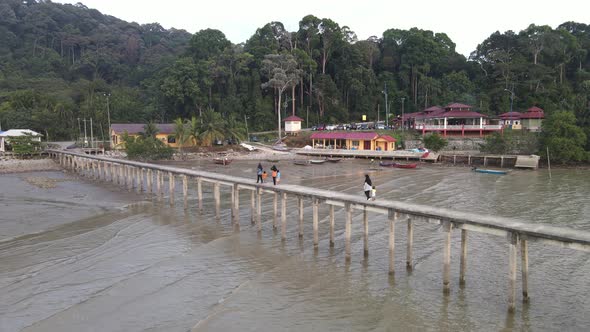 Aerial view of local villagers walking on the jetty