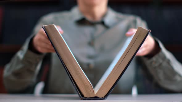 Unrecognizable Academic Woman Open Vintage Paper Book Antique Text Publication at Library Desk alt