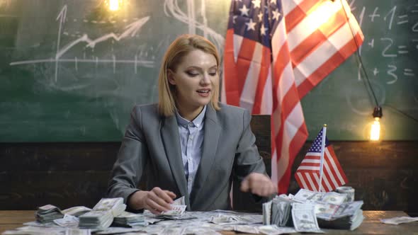 Saving Money. Businesswoman Offers Purchase. Portrait of Success Business Woman with Money Dollar alt