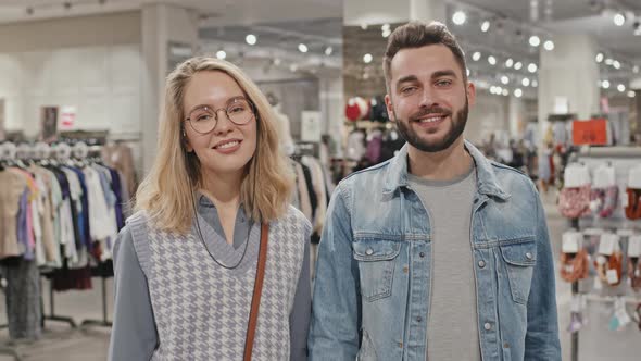 Smiling Young Couple At Clothing Store alt