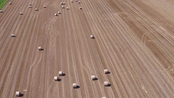 Aerial View of Stubble Field With Straw Bales alt