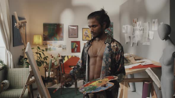 Portrait of Indian Artist Painting on Canvas alt