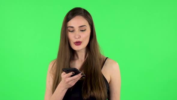 Girl Asks for Information on the Network Via Phone on Green Screen alt