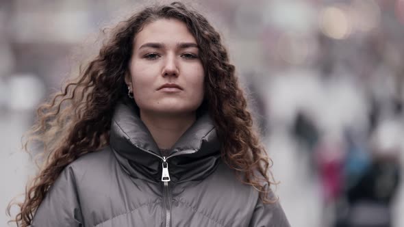 Confident Young Lady Is Walking Alone in Megapolis at Winter Day Medium Portrait Emancipation alt