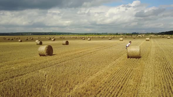 Child Boy In The Field. Child boy in the field against straw bales alt