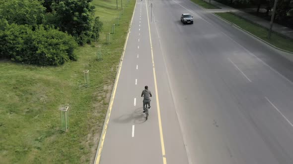 Bicycle ride on urban lane, cyclist riding a bike through city street alt