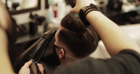 Hair Styling. Barber Completes the Haircut.  alt