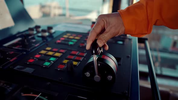 Filipino Deck Officer on Bridge of Vessel or Ship. He Is Maneuvering with Cpp Thrusters Propulsion alt