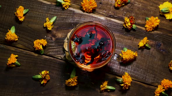 Antioxidant Red Tea On A Wooden Table, Natural From Marigold Flowers, Top View, Tea For Colds. alt
