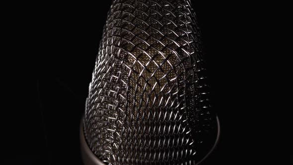 Studio Condenser Microphone Rotates on Black Background alt