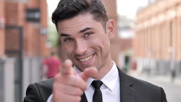 Outdoor Inviting Gesture By Young Businessman alt