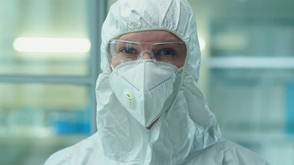 Portrait of Scientist in Protective Suit and Mask in Lab alt