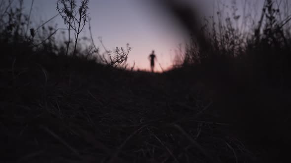 Runner In Sportswear Preparing Triathlon And Workout At Evening. Running Man Silhouette Workout. alt