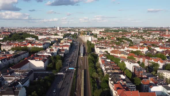 Berlin S-Bahn yellow Subway arrives at station. Calmer aerial view flight subject in of view drone alt