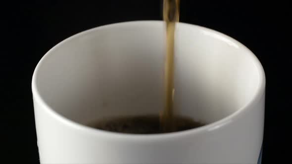 Coffee is poured into a white cup from a coffee pot close Macro shot Slow Motion video