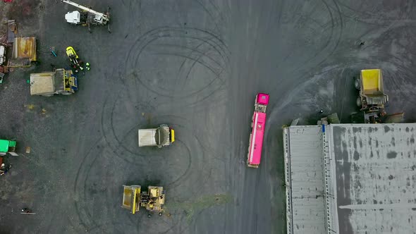 Transport Trucks Delivering Ore Material To Industrial Gold Processing Facility alt