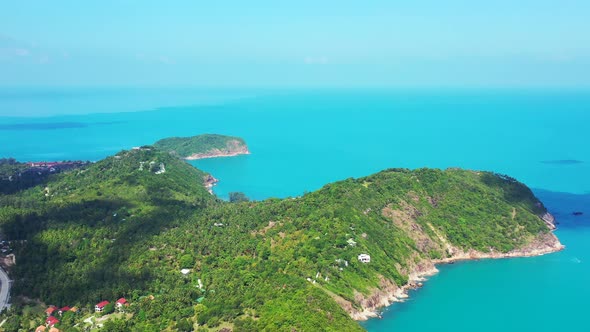 Wide above copy space shot of a white sandy paradise beach and blue water background in vibrant 4K alt