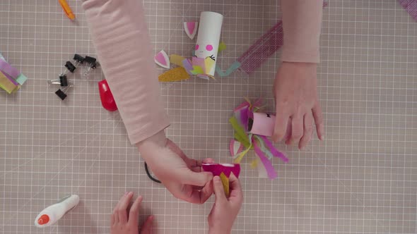 Flat lay. Step by step. Making unicorns out of paper and empty toilet paper rolls. alt