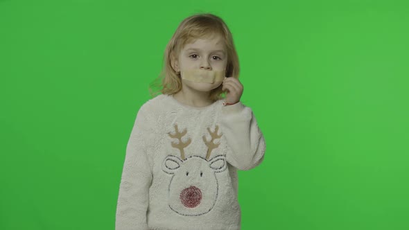 Positive Girl in Sweater with a Deer. Glued Mouth with Adhesive Tape. Chroma Key alt