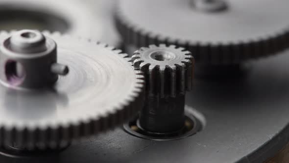 Gears rotating in a mechanical device. Machine metal gears rotating abstract alt