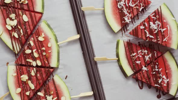 Watermelon drizzled with chocolate and topped with flaked sea salt, almonds and coconuts. alt