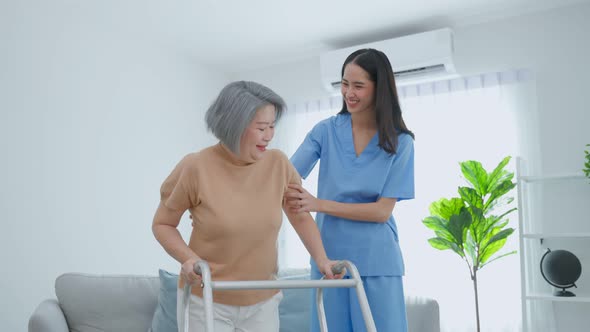 Asian senior older woman patient doing physical therapy with caregiver. alt