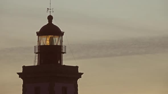 Lighthouse Lighting in the Twilight at Sunset alt