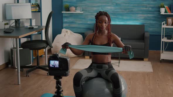 Athletic Slim Woman with Black Skin Recording Online Yoga Class Using Videocamera alt