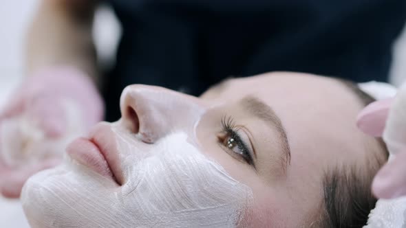 Cropped View of Beautician Removing Facial Mask From Face alt