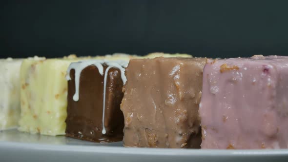 Ingots of Glazed Ice Cream of Different Colors and Flavors on a Gray Background