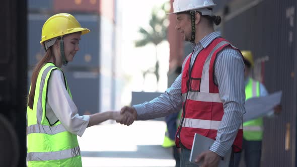 Engineer shaking hands with foreman team, Dock worker team in a shipyard