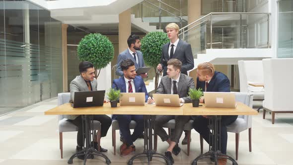 Smart Energetic Men of Different Appearance Different Nationalities Work Together As Team alt