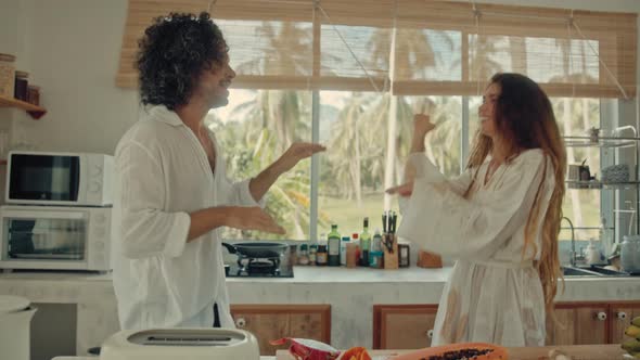 Young Happy Active Married Couple Dancing Laughing Together Cooking Meals at Home Carefree Joyful alt