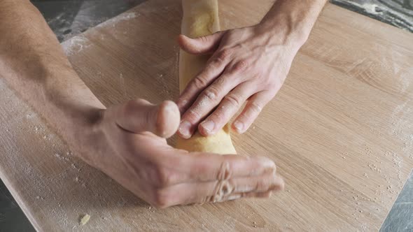 Baker Chef Working with Dough on the Table alt