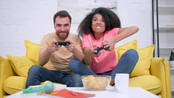 Couple playing video games together.