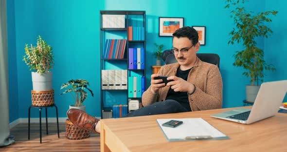 Handsome Mature Office Worker with Glasses is Lazy at Work Doesn't Complete Duties Takes a alt