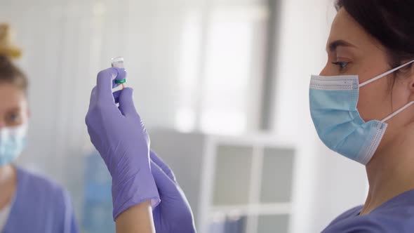 Video of female doctor preparing woman for vaccination. Shot with RED helium camera in 8K. alt