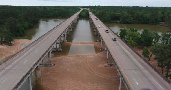 Aerial of cars driving on bridge that crosses over the San Jacinto River in Houston, Texas alt