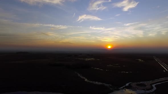 The setting sun hangs just above the horizon, Ibera Wetlands, Corrientes Province, Argentina alt