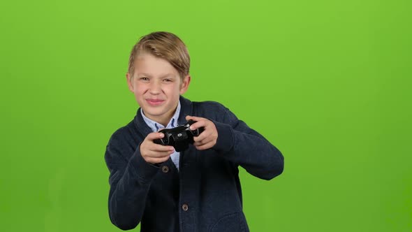 Boy Plays on the Joysticks. Green Screen alt