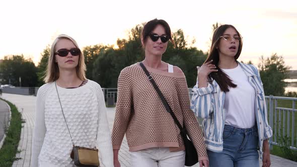 Attractive Young Models in a Stylish Outfits Walking. alt