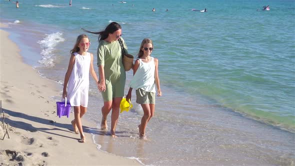 Adorable Little Girls and Young Mother on Tropical White Beach
