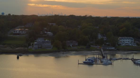 Rising Aerial From Boats Docked at Marina to New York City Skyline at Sunset alt