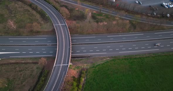 Aerial View of Highway Road Intersection with Fast Moving Heavy Traffic alt